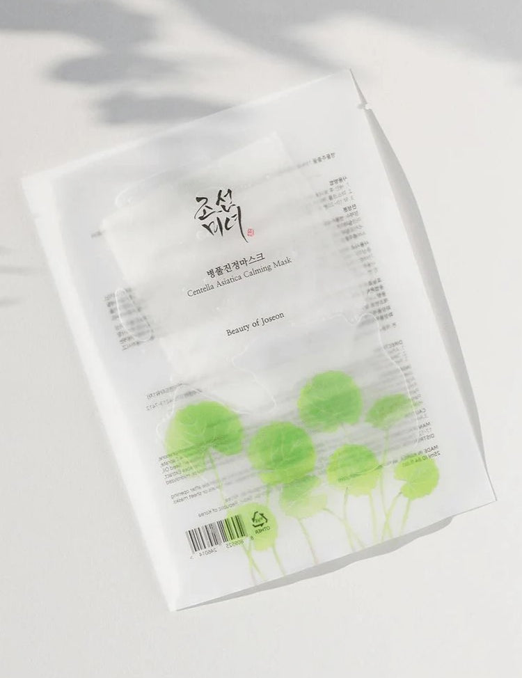 A pack of Centella Asiatica Calming Mask by Beauty of Joseon, featuring a minimalist design with Centella plant illustrations, highlighting its soothing benefits.