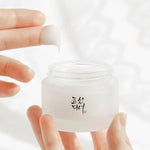 Close-up of Beauty of Joseon Dynasty Cream, with a finger scooping its smooth, rich texture.