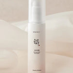 A sleek bottle of Beauty of Joseon Ginseng Moist Sun Serum, labeled SPF 50+ PA++++, set against a soft, neutral background.