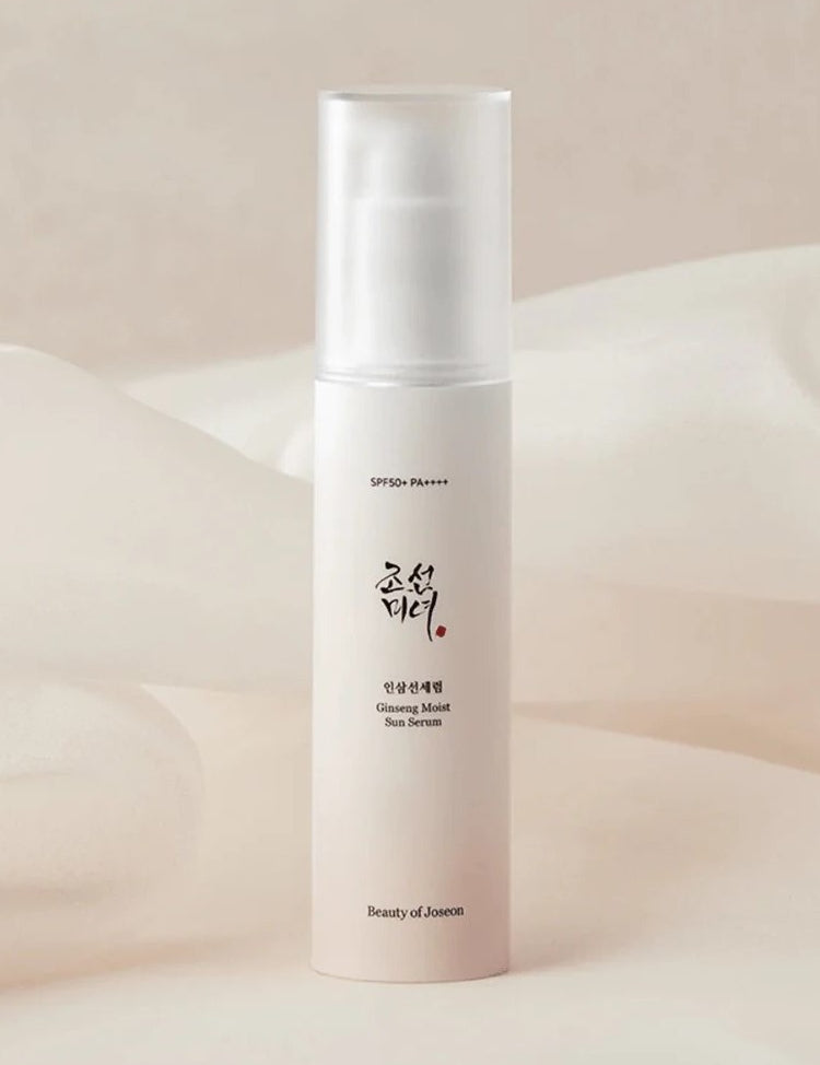 A sleek bottle of Beauty of Joseon Ginseng Moist Sun Serum, labeled SPF 50+ PA++++, set against a soft, neutral background.