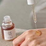 beauty of joseon revive serum ginseng and snail mucin texture with hands