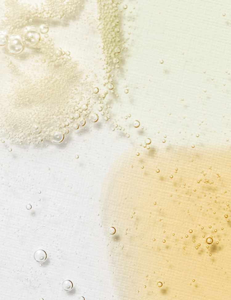Close-up of bubbles in various shades floating on a white surface, showcasing the different textures of the Beauty of Joseon Serum collection.