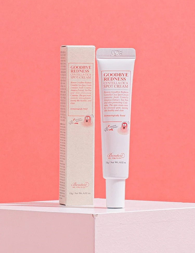 Benton Goodbye Redness Centella Spot Cream tube with packaging on a pastel pink background, emphasizing soothing skincare for sensitive, stressed skin.