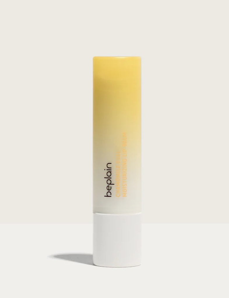 A tube of Beplain Chamomile Intense Moisturizing Lip Balm with a gradient yellow design, set against a neutral background.