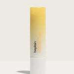 A tube of Beplain Chamomile Intense Moisturizing Lip Balm with a gradient yellow design, set against a neutral background.