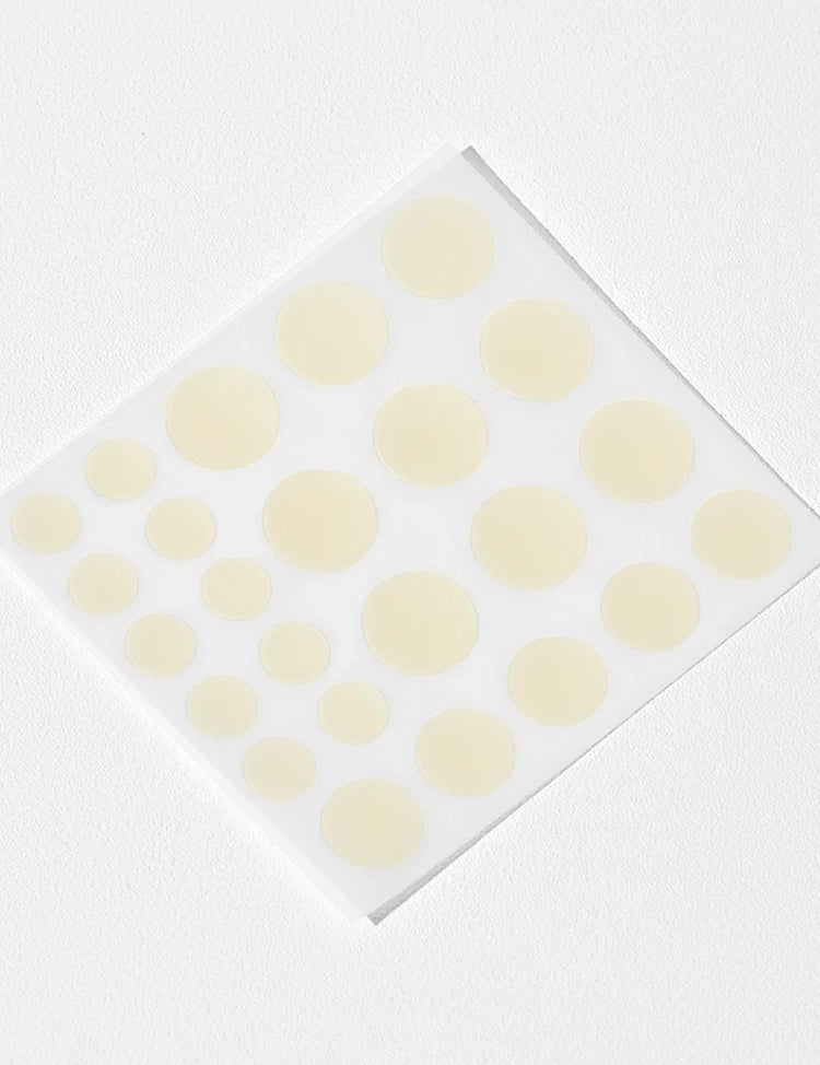 Cosrx Acne Pimple Master Patches in various sizes, arranged on a transparent backing, set against a white background.