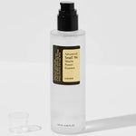A bottle of Cosrx Advanced Snail 96 Mucin Power Essence with a black pump beside its small transparent cap on a light background.