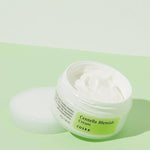 Opened jar of Cosrx Centella Blemish Cream, highlighting its smooth, creamy texture, set against a pastel green background for soothing skincare.