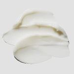 Close-up of the creamy texture of Cosrx Ceramide Cream on a light gray background.