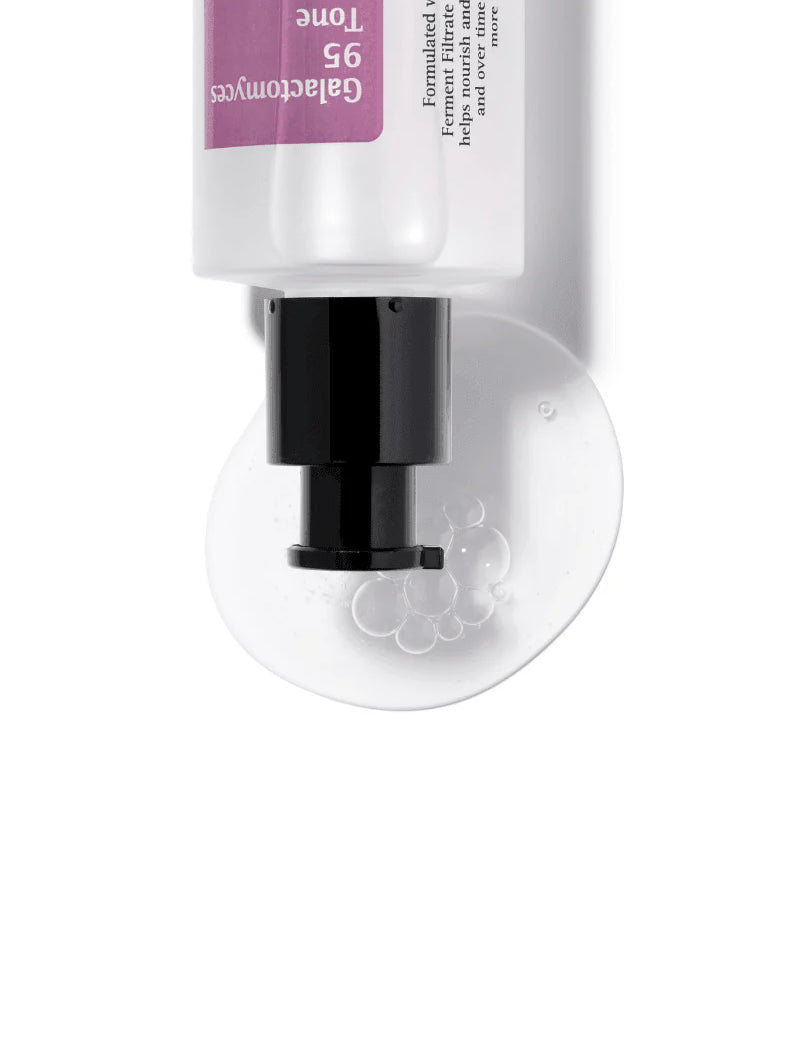 Cosrx Galactomyces 95 Tone Balancing Essence dispensing its gel-like texture with bubbles onto a smooth surface.