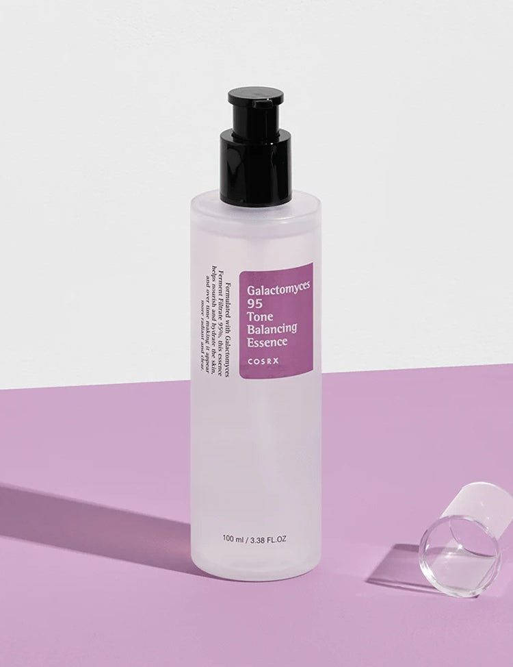 Cosrx Galactomyces 95 Tone Balancing Essence on a purple surface, highlighting its sleek and minimalist design.