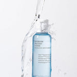 A blue bottle of Cosrx Hydrium Watery Toner splashed with water, emphasizing its hydrating ingredients.