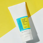 A tube of Cosrx Low pH Good Morning Gel Cleanser on a bright yellow background, highlighting its minimalist design and blue label.