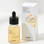 A bottle of Cosrx Propolis Light Ampoule with a dropper, placed beside its minimalist white packaging displaying product details.