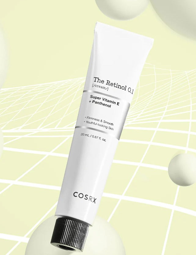 A tube of Cosrx Retinol 0.1 Cream on a soft yellow background, with Vitamin E and Panthenol highlighted on its label to promote youthful-looking skin.