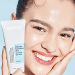 A model holding a Cosrx Ultimate Nourishing Rice Overnight Spa Mask tube, showcasing the mask’s glass skin effect on her glowing complexion.