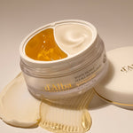 A jar of d'Alba White Truffle Double Serum & Cream, showcasing its gold jelly and white cream formula designed to hydrate and nourish the skin.