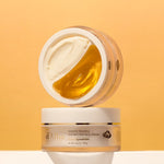 Two jars of d'Alba's White Truffle Double Serum and Cream on a soft orange background, showcasing creamy and golden texture.