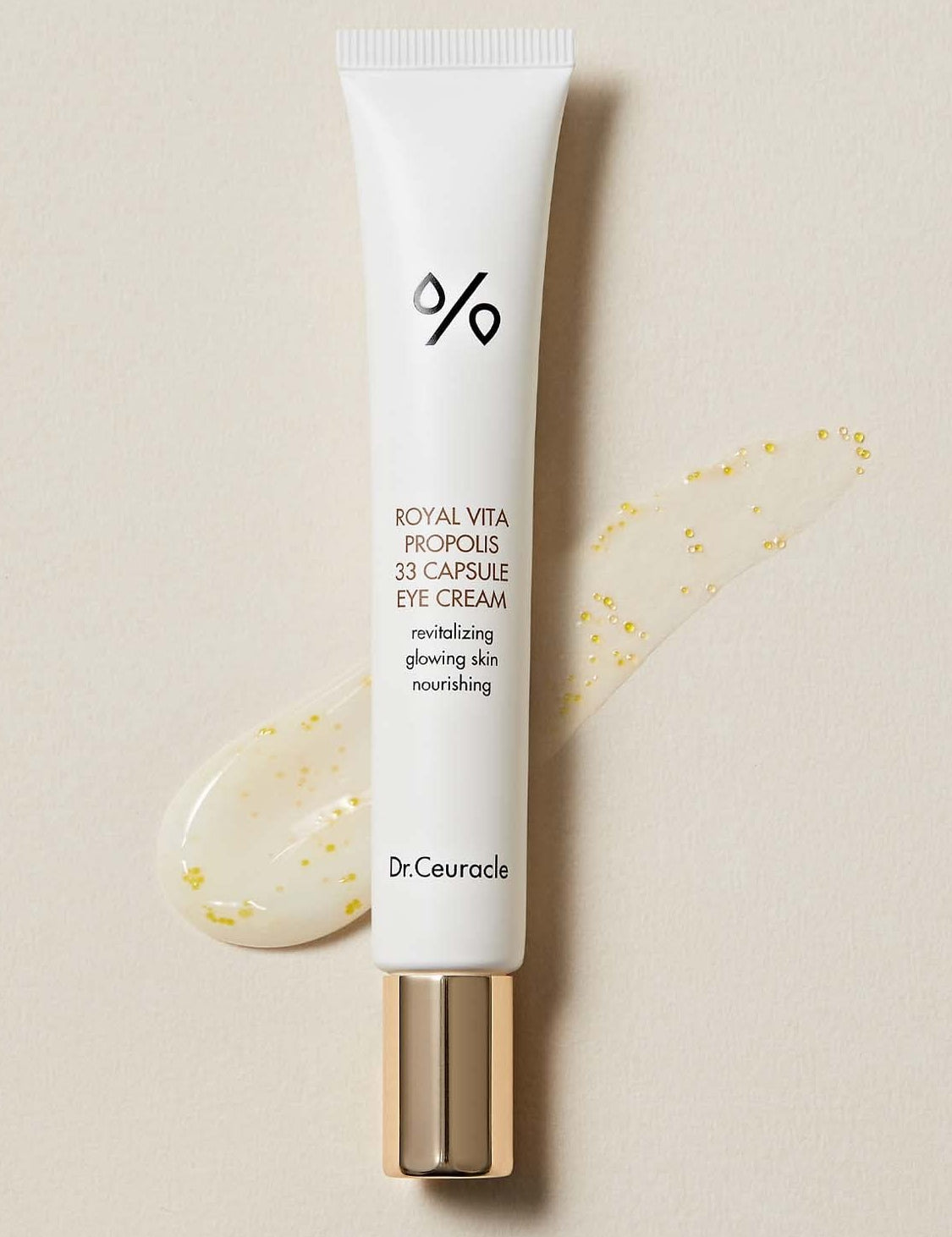 A tube of Dr. Ceuracle Royal Vita Propolis 33 Capsule Eye Cream, showcasing its glossy texture with golden Propolis beads for radiant, anti-aging benefits.