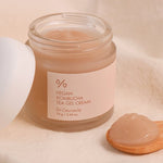A jar of Dr. Ceuracle Vegan Kombucha Tea Gel Cream with a wooden scoop holding a dollop of its translucent, lightweight gel texture.