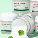 Five jars of Dr.G Red Blemish Cica Soothing Cream on a mint background, with one tipped over to reveal the creamy texture alongside Centella Asiatica leaves, emphasizing its soothing CICA ingredients.