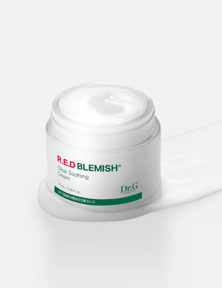 Open jar of Dr.G Red Blemish Cica Soothing Cream with smooth white cream texture spilling beside it, highlighting its lightweight yet nourishing formula.
