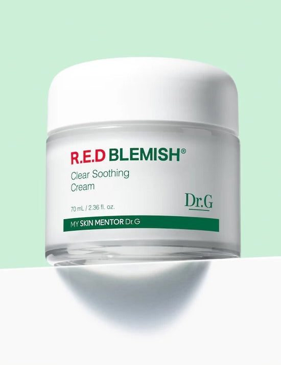 A jar of Dr.G Red Blemish Cica Soothing Cream on a mint background, featuring its clean, minimalist packaging design.