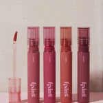 Four lip products in pink and coral shades from the Etude House Fixing Tint Collection, with an applicator displayed, arranged against a neutral background.