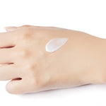 A pale hand on a white background with a dollop of Etude House Moistfull Collagen Eye Cream on the palm, showcasing its smooth texture.