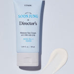 A tube of Etude House Soon Jung x Director's Moisture Sun Cream SPF 50+ placed beside a smooth white cream swatch on a light background.