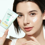 A model holds a tube of Etude House Sunprise Mild Watery Light Sunscreen, showcasing its lightweight texture on her cheek against a bright, neutral background.