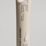 Close-up of Haruharu Wonder Black Rice Bakuchiol Eye Cream tube showing its smooth texture, highlighting key ingredients Black Rice and Bakuchiol, formulated to reduce fine lines and wrinkles.