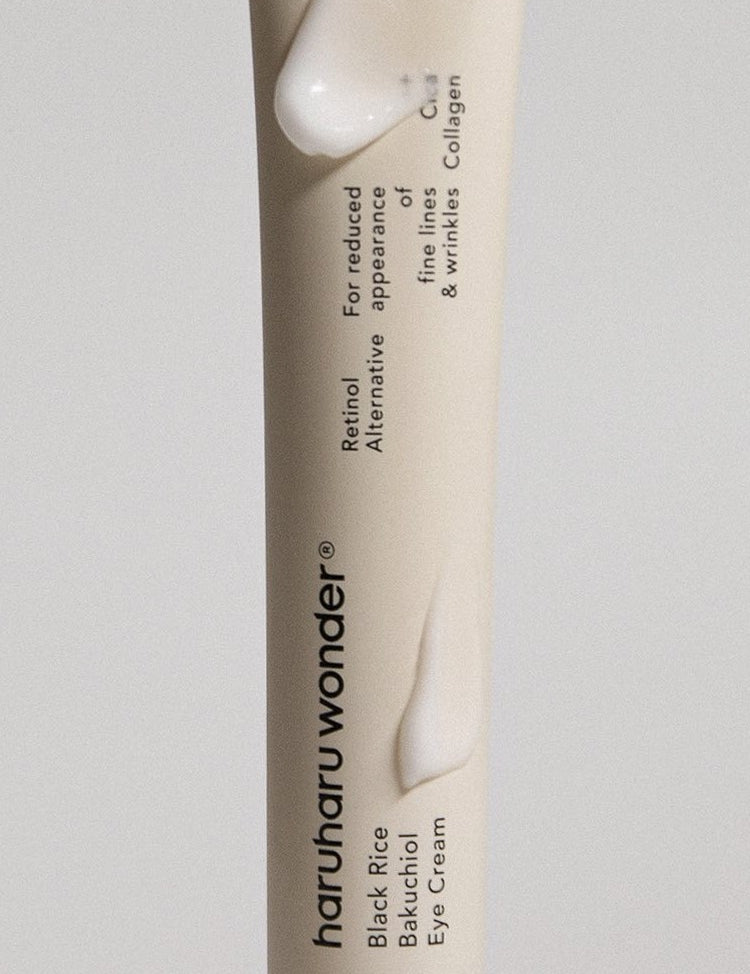 Close-up of Haruharu Wonder Black Rice Bakuchiol Eye Cream tube showing its smooth texture, highlighting key ingredients Black Rice and Bakuchiol, formulated to reduce fine lines and wrinkles.
