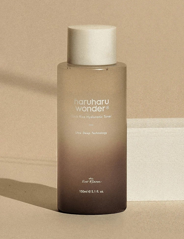 A sleek bottle of Haruharu Wonder Black Rice Hyaluronic Toner on a neutral background, showcasing its minimalist design and branding.