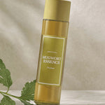 A bottle of 'I'm From' Mugwort Essence set against a soft background, with green Mugwort leaves nearby.