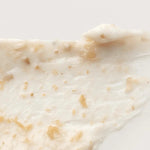 Close-up of the creamy white texture of the 'I'm From' Rice Mask, flecked with small rice hull particles for gentle exfoliation.