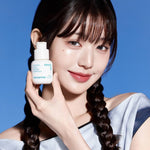 A model with long braided hair holds an Innisfree Retinol Cica Repair Ampoule against a bright blue background.