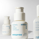 Three white bottles of Innisfree's Retinol Cica Repair Ampoule, each labeled with blue text, on a minimalist backdrop.