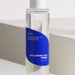 Clear bottle of Isntree Hyaluronic Acid Toner with a blue label, designed to provide deep hydration for all skin types; 200 ml size on a light background.
