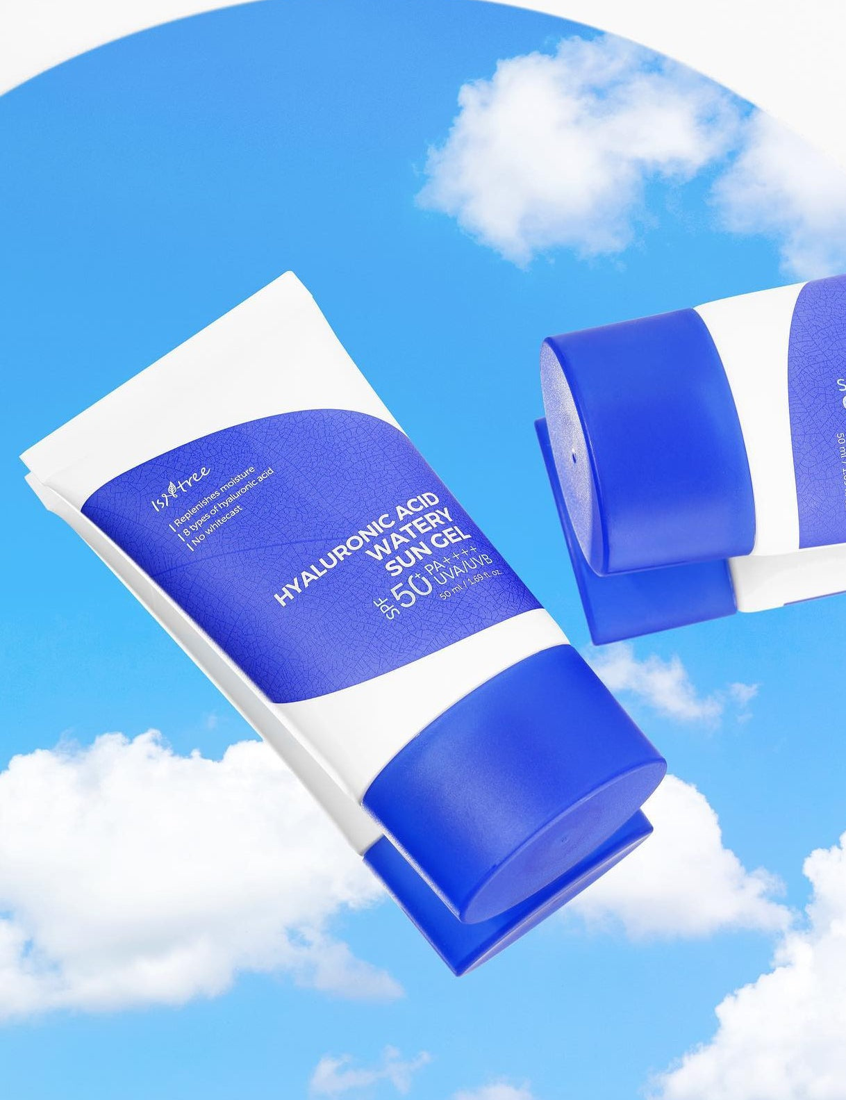 Two tubes of Isntree Hyaluronic Acid Watery Sun Gel against a bright blue sky with clouds, highlighting their vibrant packaging.