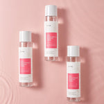 Three bottles of iUNIK Rose Galactomyces Essential Toner on a pink background, highlighting product branding and skincare benefits.