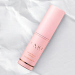 A pink cylinder container of Kahi Wrinkle Bounce Multi Balm with Jeju Origin Oil, placed on a crumpled white paper background.