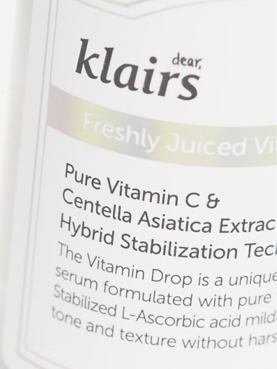 Close-up of Klairs Freshly Juiced Vitamin Drop serum bottle, emphasizing key ingredients like Pure Vitamin C and Centella Asiatica, renowned for their brightening and soothing benefits.