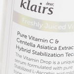Close-up of Klairs Freshly Juiced Vitamin Drop serum bottle, emphasizing key ingredients like Pure Vitamin C and Centella Asiatica, renowned for their brightening and soothing benefits.