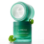 A green jar of Laneige Cica Sleeping Mask opened to reveal creamy texture, with a Centella Asiatica leaf beside it on a white background, highlighting its key ingredient.