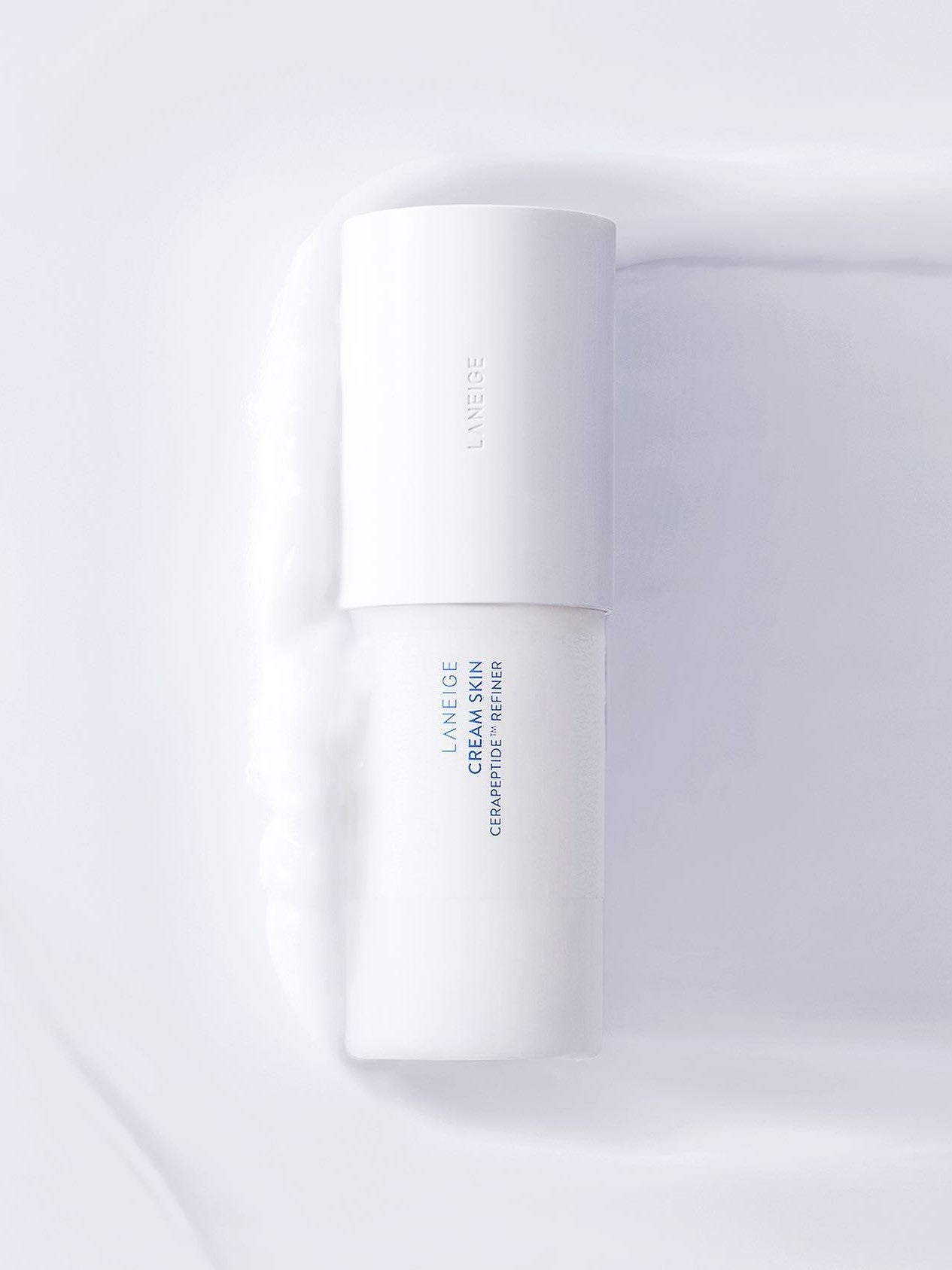 Laneige Cream Skin Cerapeptide™ Refiner set on its milky texture, showcasing a minimalist design.