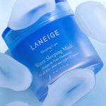 A blue jar of Laneige Water Sleeping Mask on a light background, surrounded by translucent gel droplets, highlighting its hydration and refreshing effect.