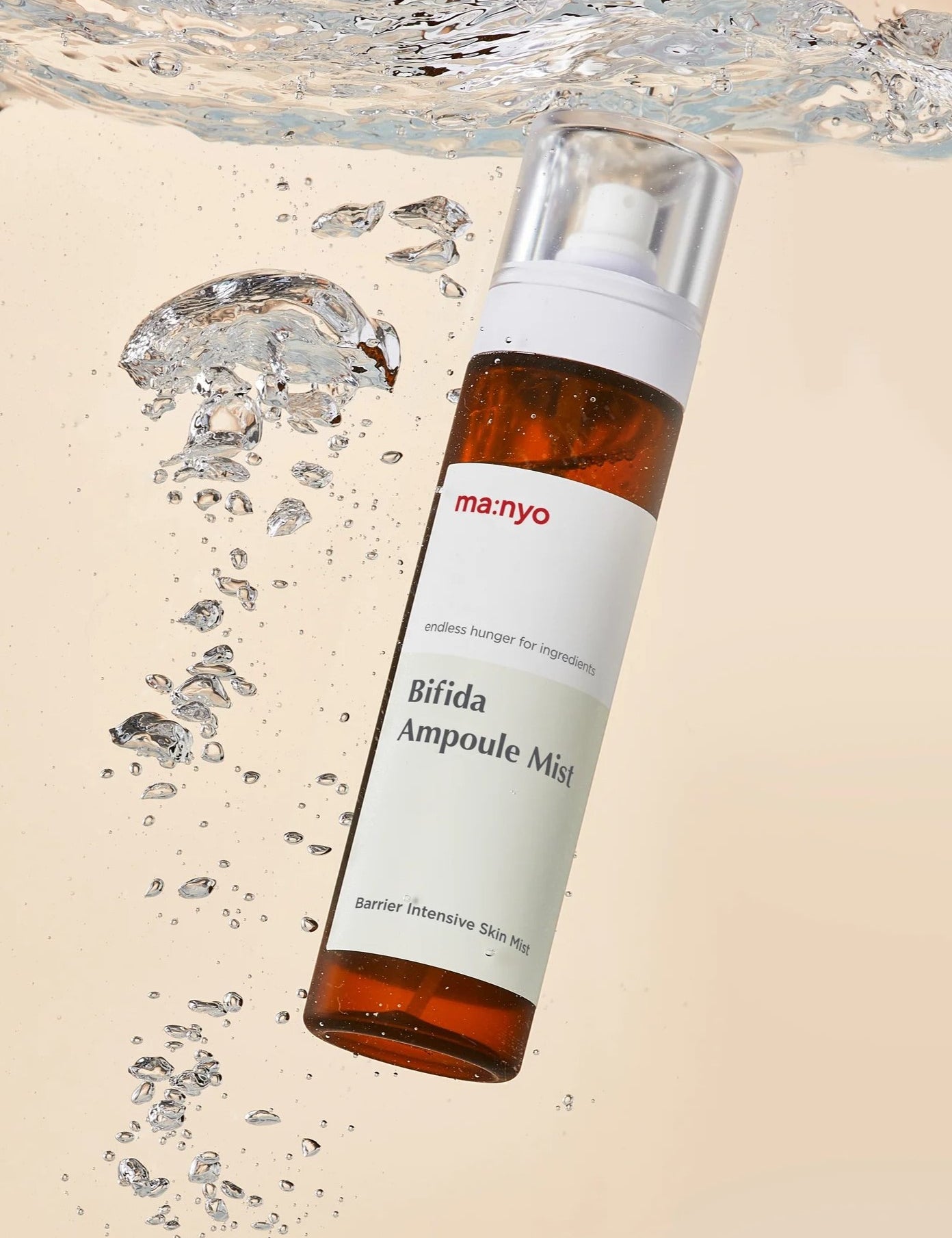 Bottle of Manyo Bifida Ampoule Mist floating in water with droplets, emphasizing its barrier-strengthening and hydrating benefits.