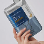 A person holds a Mediheal N.M.F Nude Gel Mask packaging with a blue design, emphasizing hydration and soothing benefits.