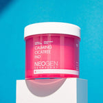 Bright pink jar of Neogen Dermalogy Calming Cicatree Pad displayed on a white pedestal against a vibrant blue background, highlighting its soothing benefits.